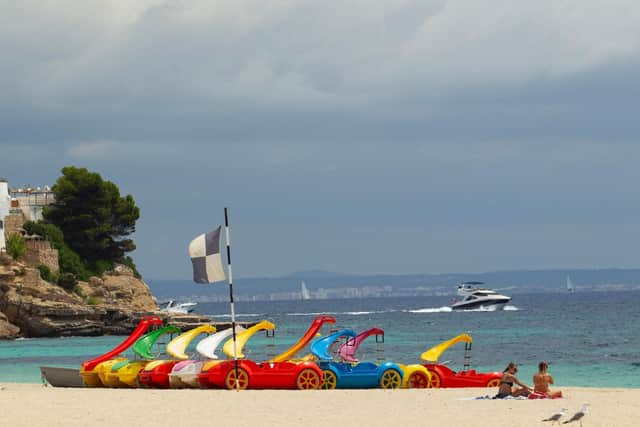 Women sunbath in Magaluf, Calvia, in Spain's Balearic island of Majorca on July 16, 2020