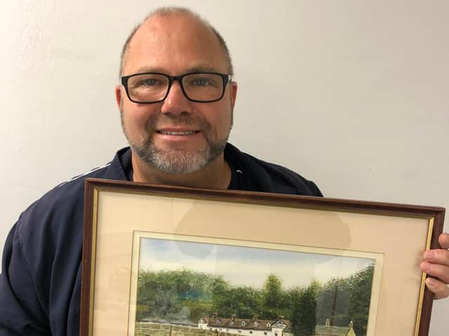 Tony Heath with one of the paintings he bought