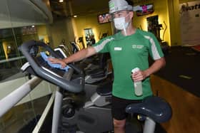 Gyms that reopen must follow strict hygiene and social distancing measures, such as limiting the number of people using the facility and spacing out equipment.