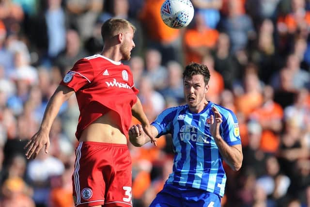 Ben Heneghan challenges Connor Simpson in Blackpool's clash with Accrington Stanley