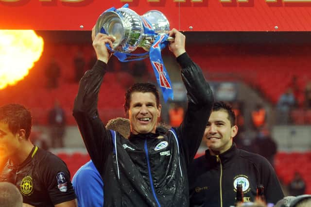 Mike Pollitt lifts the FA Cup during his time with Wigan Athletic