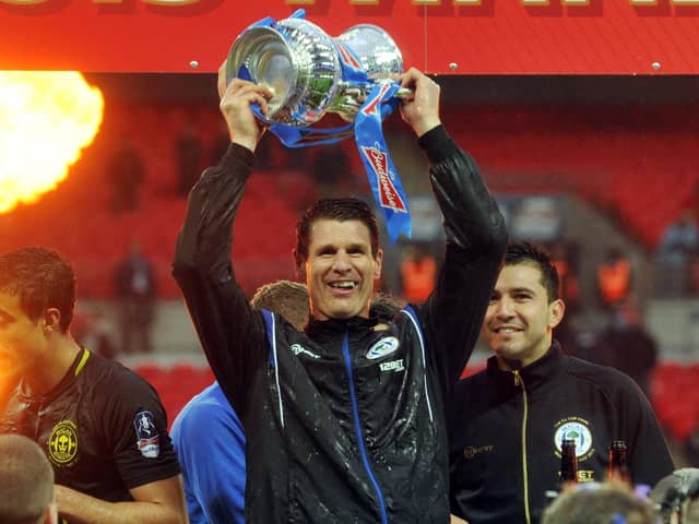 Mike Pollitt lifts the FA Cup during his time with Wigan Athletic