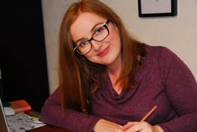 Sarah at work at her desk