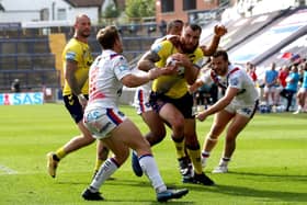 Wigan Warriors' Jake Bibby (second right) goes over for a try against Wakefield. Picture: PA.