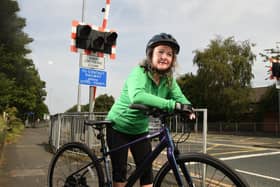 Pam on her bike at the Strand Road rail crossing where she had an accident
Photos: NEIL CROSS