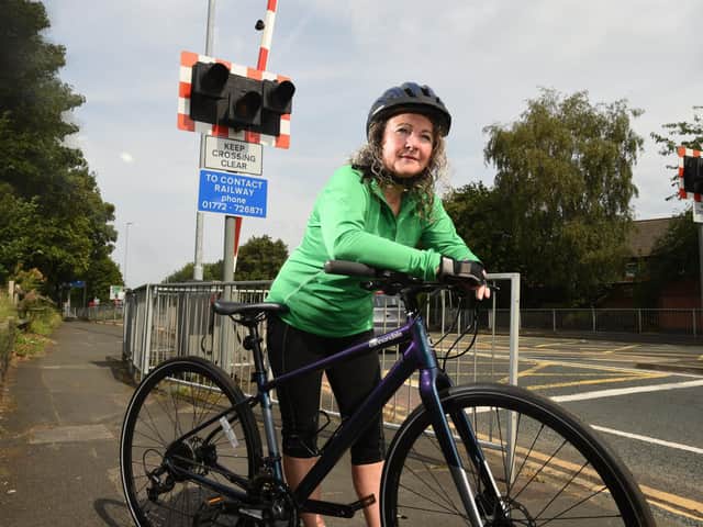 Pam on her bike at the Strand Road rail crossing where she had an accident
Photos: NEIL CROSS