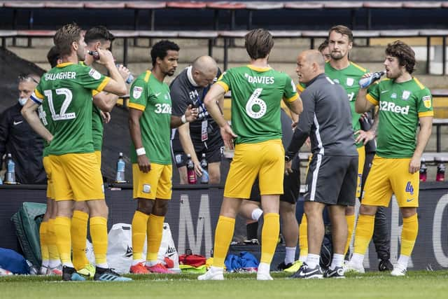 Preston North End players with Alex Neil during one of the drinks breaks in the game against Luton at Kenilworth Road