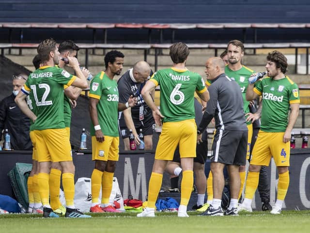 Preston North End players with Alex Neil during one of the drinks breaks in the game against Luton at Kenilworth Road