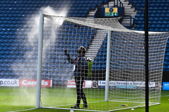 The goalposts are sprayed during a break in play at Deepdale