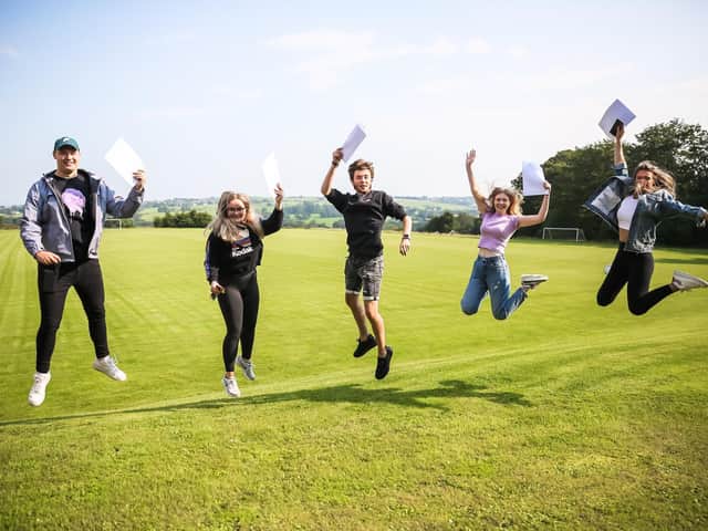 A Level students jump for joy at Westholme School