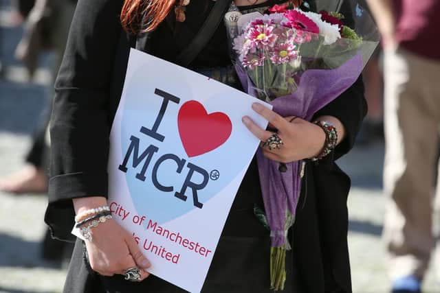 Someone holding a sign at a vigil for the blast at the Manchester Arena. The mother of one of the victims has described how she had to "switch the emotions off" when she came face-to-face with one of the two brothers responsible for the massacre.