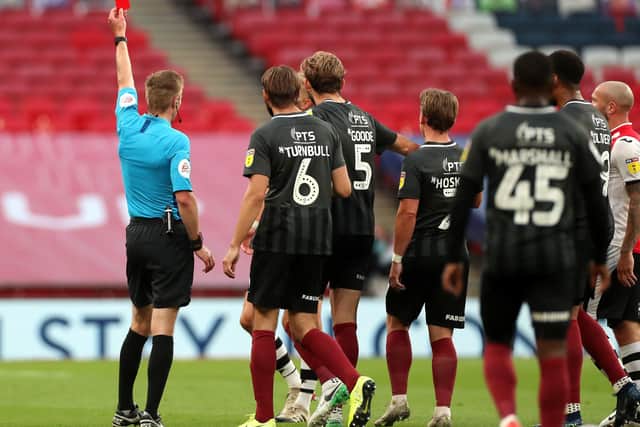 Referee Michael Salisbury shows Exeter City's Dean Moxey (hidden) the red card during the League Two Play-Off final at Wembley Stadium