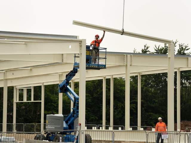 A steel beam is lowered into place