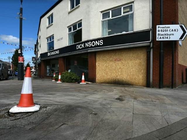 The smashed showroom window has been boarded up