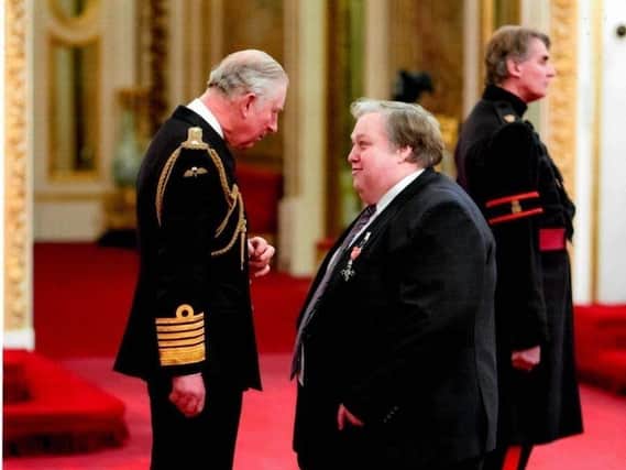 Simon Rigby receiving his MBE from Prince Charles in 2017