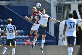 Preston North Ene defender Jordan Storey challenges Burnley striker Jay Rodriguez at Deepdale    Picture courtesy of PNE