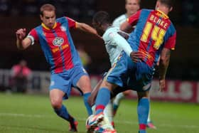 Jeffrey Monakana battles for possession against two Crystal Palace players