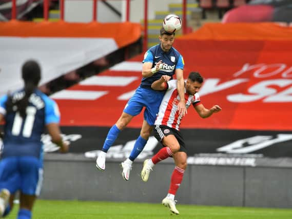 Preston North End left-back Andrew Hughes challenges in the air against Sheffield United at Bramall Lane  Pic courtesy of PNE