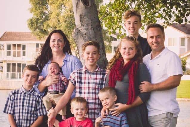 Dad-of-seven Ben Woodward with his family, who now live in California.