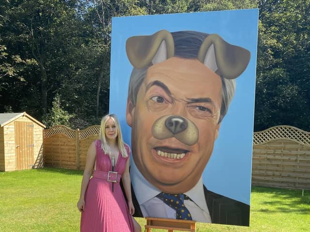 Artist Lucy Morris with her distinctive painting of Nigel Farage
