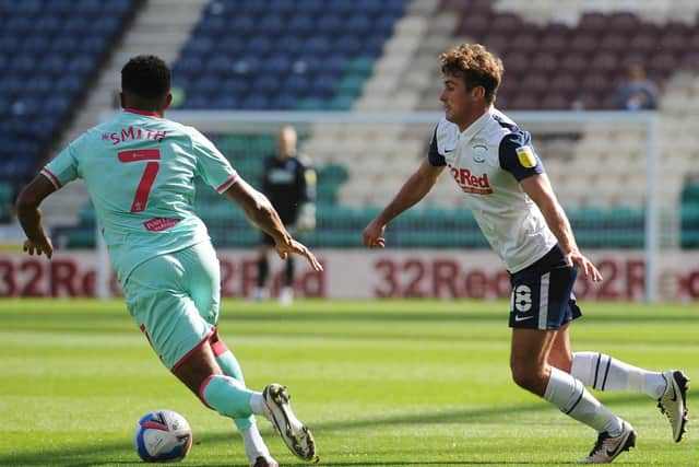 Preston North End midfielder Ryan Ledson moves to challenge Swansea's Korey Smith