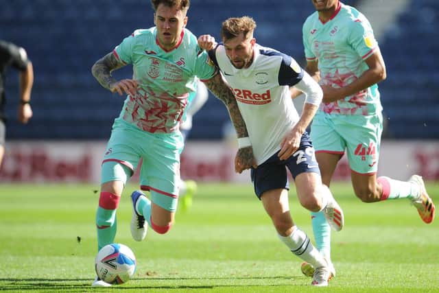PNE's Tom Barkhuizen takes on Swansea defender Joe Rodon