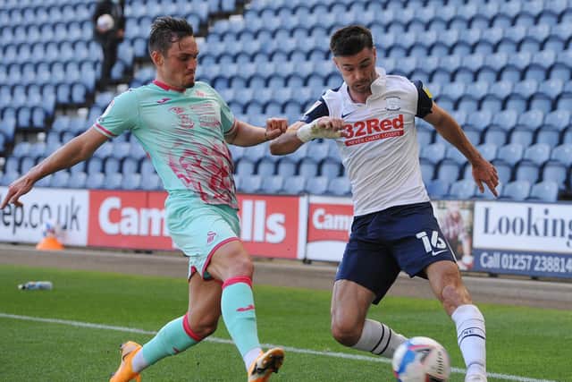 PNE left-back Andrew Hughes tries to cross the ball under pressure from Connor Roberts