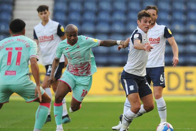 Preston North End midfielder Ryan Ledson in the thick of the action against Swansea at Deepdale