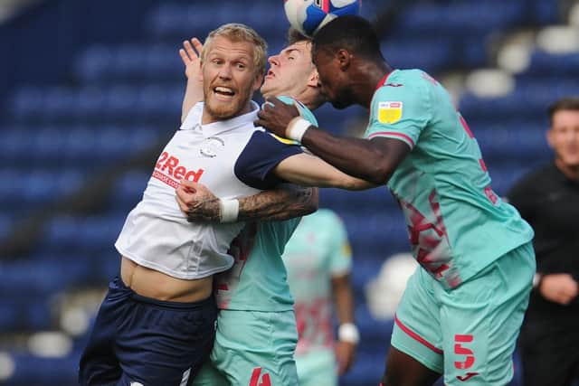 PNE substitute Jayden Stockley challenges in the air with Swansea's Joe Rodon and Marc Guehi