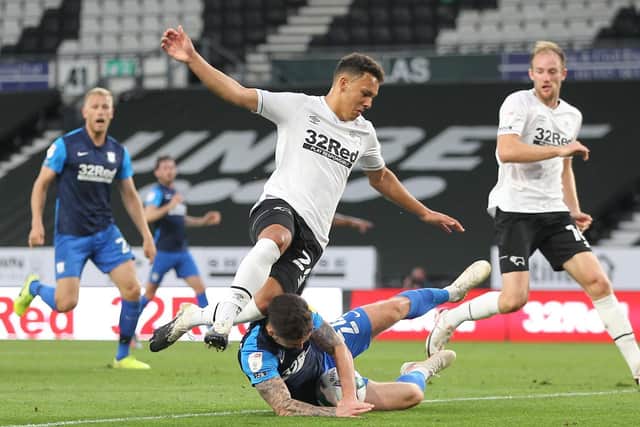 Preston North End's Sean Maguire gets the ball stuck under his body as he slides in to meet a cross against Derby