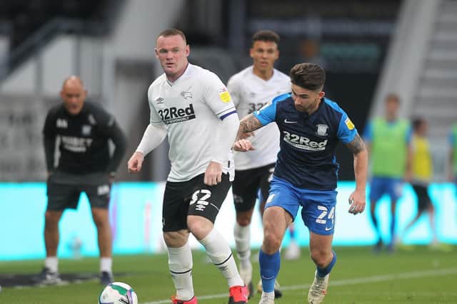 Sean Maguire and Wayne Rooney compete