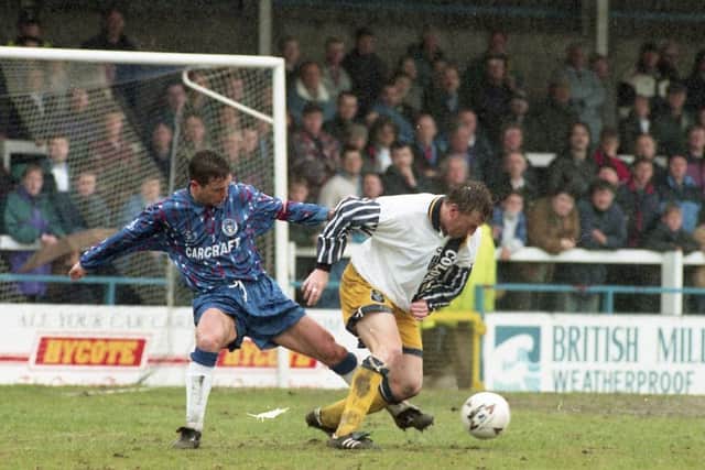 Paul Raynor shields the ball from a Rochdale defender
