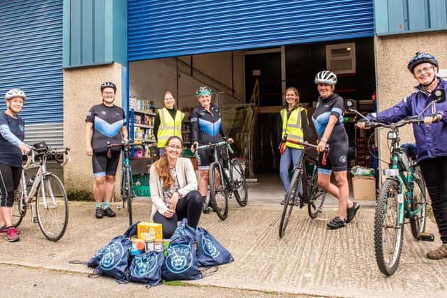 Members of Lancaster Women's Cycling group donated cash from the sale of their cycling bags to The Olive Branch assistant project manager Lesley Stephens (centre) and volunteers from the charity. Photo by Sarah Peters.