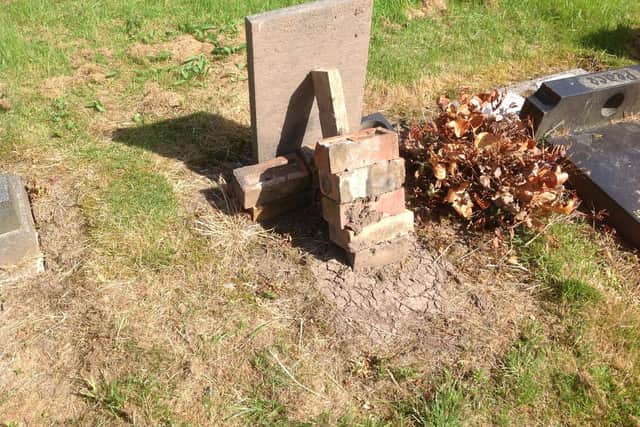 An example of a dangerous 'fix' attempted by a family member. Contact the vicar before trying to stabilise a headstone.