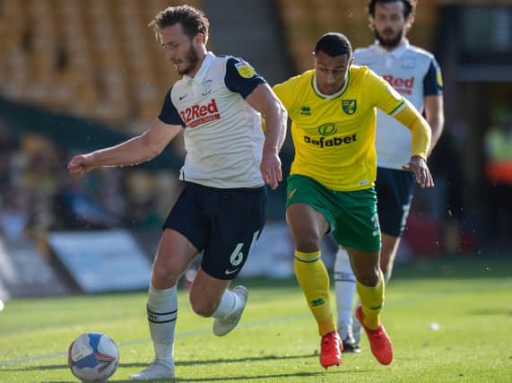 Ben Davies shields the ball against Norwich City's Adam Idah