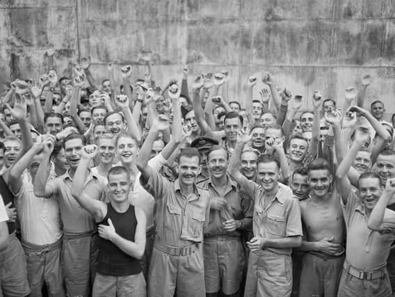 Allied prisoners of war celebrating their liberation from Changi Jail, Singapore, in 1945