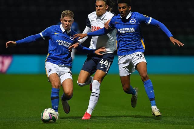 PNE midfielder Brad Potts finds his path blocked by two Brighton players at Deepdale