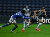 PNE winger Billy Bodin tries to escape the clutches of Brighton's Bernando Fernandes at Deepdale