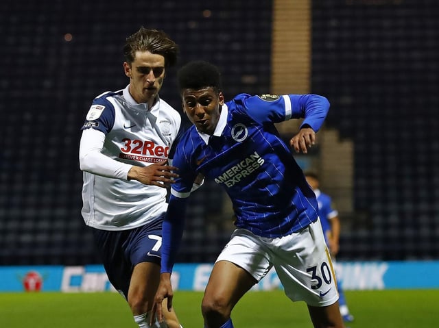 Preston midfielder Tom Bayliss tussles with Brighton's Bernardo