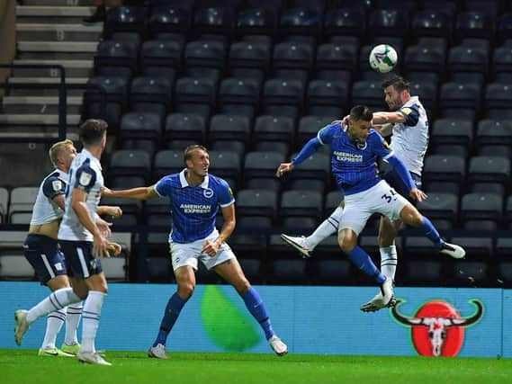 Andrew Hughes challenges for the ball in the 2-0 defeat to Brighton.