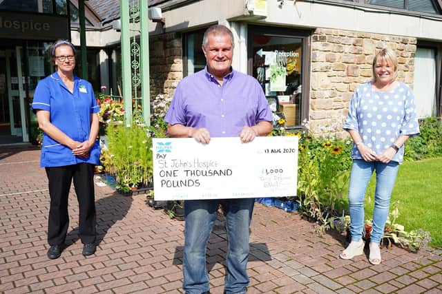 Terry Deehan delivering his cheque with his boss, Donna Knowles and Jaqueline Edgecombe, a Hospice at Home nurse.