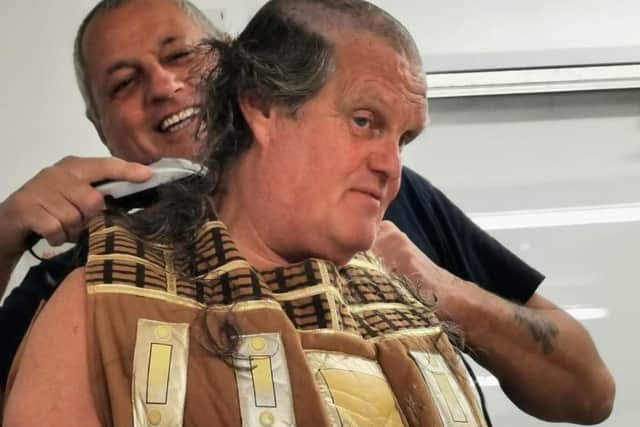 Terry Deehan mid-shave with a colleague.