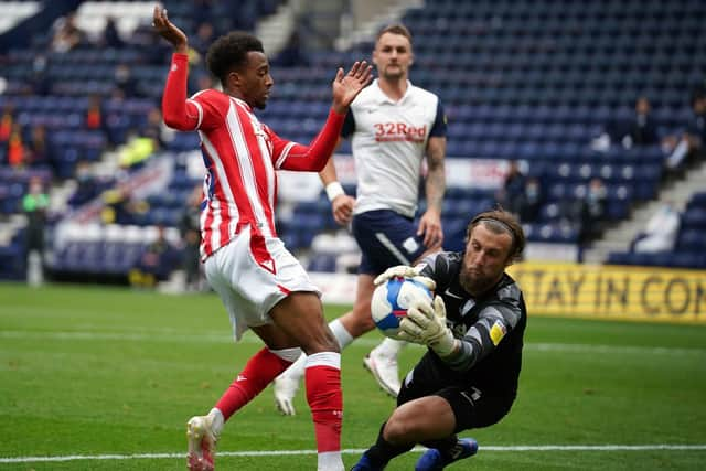 Preston North End goalkeeper Declan Rudd saves at the feet of Stoke midfielder Tasham Oakley-Boothe