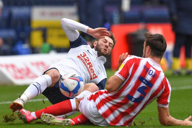 Preston North End's Tom Barkhuizen and Stoke's Morgan Fox slid in, with Barkhuizen receiving a red card