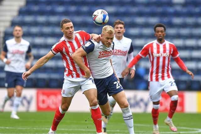 Preston striker Jayden Stockley battles against Stoke defender James Chester