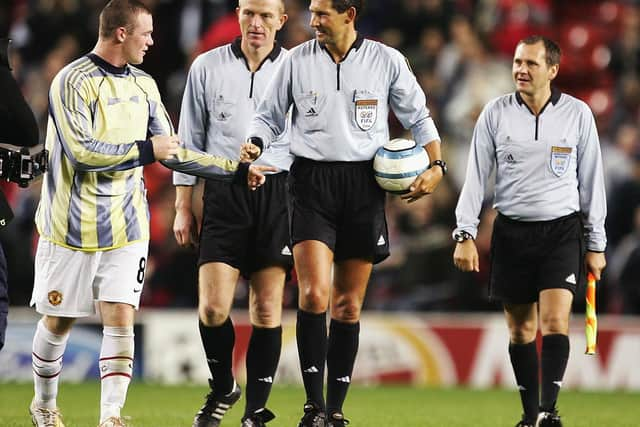 Wayne Rooney tries to get the matchball from the referee after a hat-trick on his debut during the Champions League Group D match between Manchester United and Fenerbahce at Old Trafford on September 28, 2004