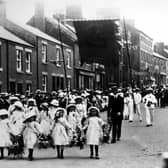 Kirkham and Wesham Club day procession - early 1900s - along Poulton Street, Kirkham, led by little flower girls, with brass band in background