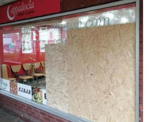 The boarded up window which burglars smashed to get in.