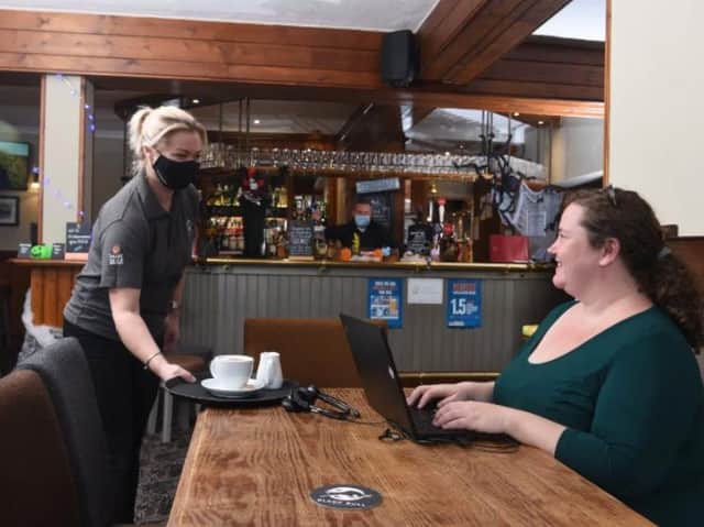 Janine serves coffee to Helena Scott who booked in to work from the pub.