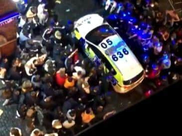 Crowds surrounded police cars after officers were called to disperse revellers outside pubs and clubs in Liverpool city centre last night (Tuesday, October 13)